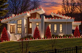 Design rendering: Modern home with Christmas roofline lights and red decorated trees at sunset