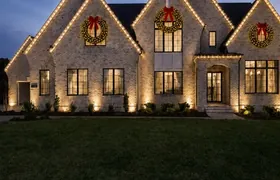 Design rendering: Gabled home with Christmas roofline lights and wreaths at dusk