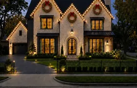 Design rendering: Stone home with Christmas lights tracing three front gables