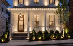 Design rendering: Townhome with Christmas roofline lights and a wreath above the upper windows