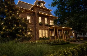 Design rendering: Brick home with Christmas roofline lights and illuminated trees